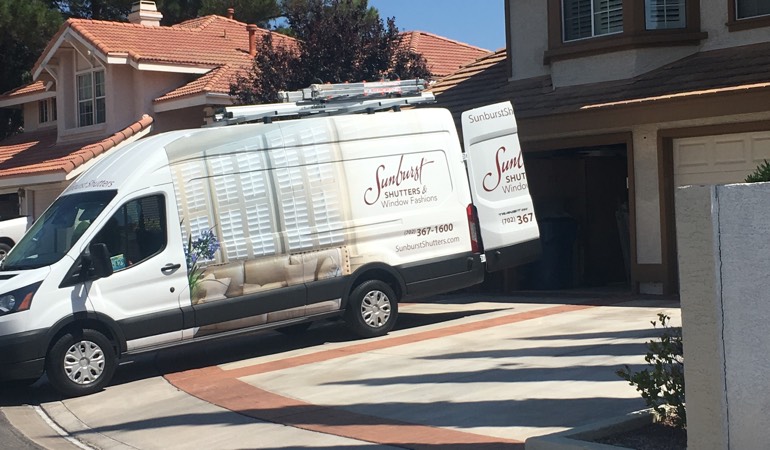 Alt text: Sunburst Shutters van parked at customer's home.